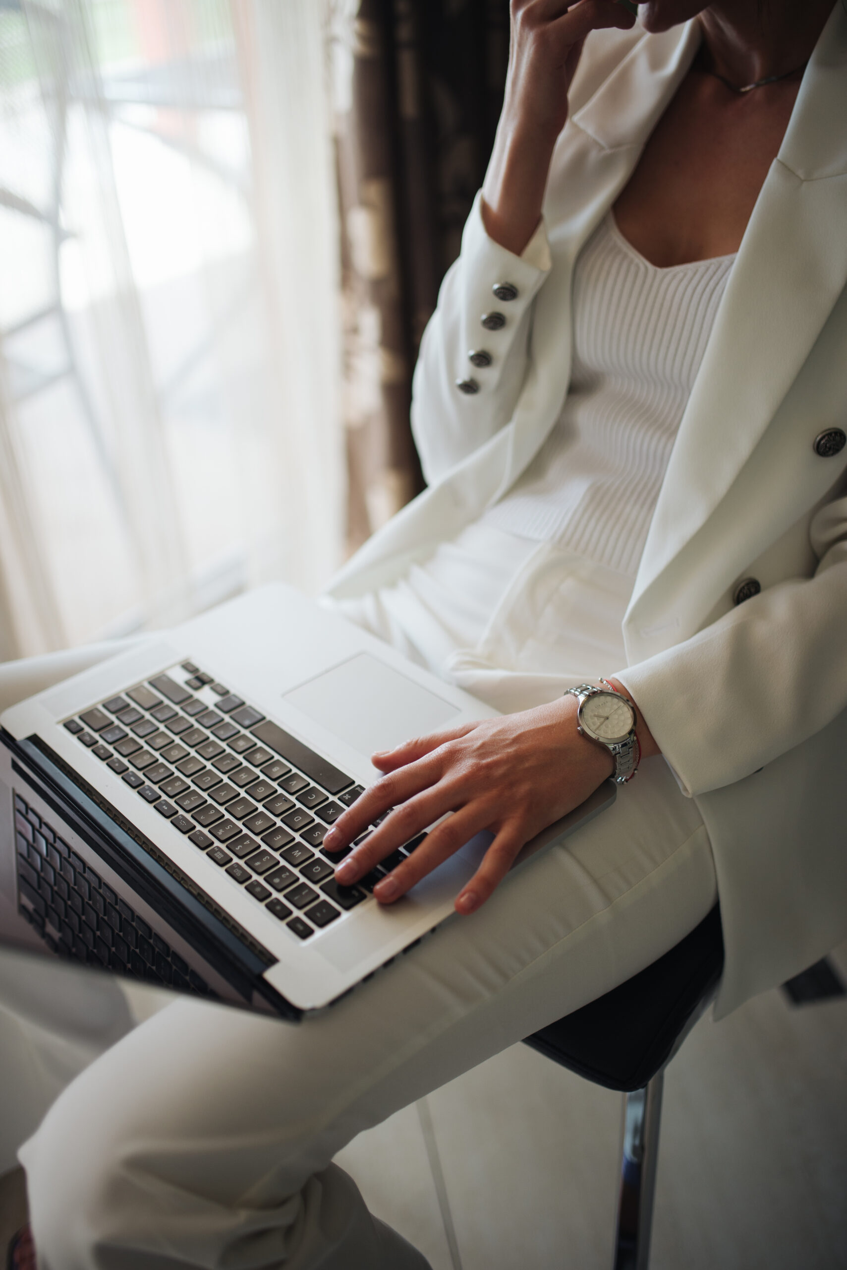 Business professional working on a laptop in a bright office