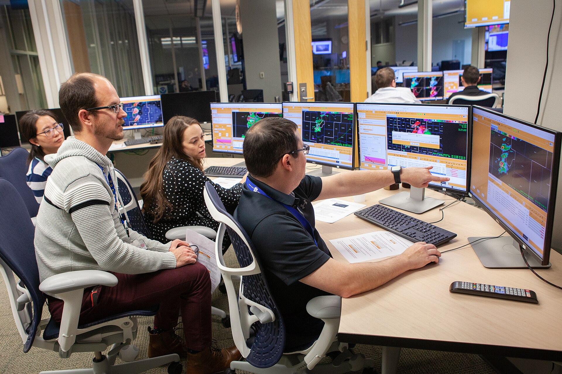 People collaborating around computer workstations